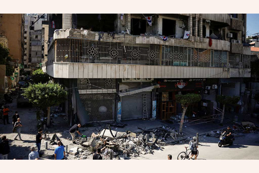 People and members of press look at a damaged building at the site of an Israeli strike on central Beirut’s Bachoura neighbourhood, amid ongoing hostilities between Hezbollah and Israeli forces, in Beirut, Lebanon October 3, 2024.