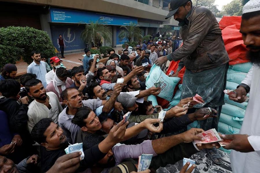 People buying subsidised flour sacks from a truck in Karachi in Pakistan on January 10 this year –Reuters file photo