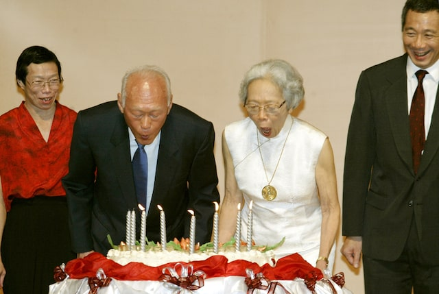 Lee Kuan Yew, architect of modern Singapore, and his wife Kwa Geok Choo (2nd R) blow out candles on a birthday cake as they celebrate his 80th birthday in Singapore, September 16, 2003. Lee turned 80 on Tuesday but his vow to stay in government has deepened debate over how soon his son, Hsien Loon (R) should become prime minister - and whether the elder Lee should retire. Looking on is elder Lee's daughter, Lee Wei Ling. REUTERS/David Loh/File photo