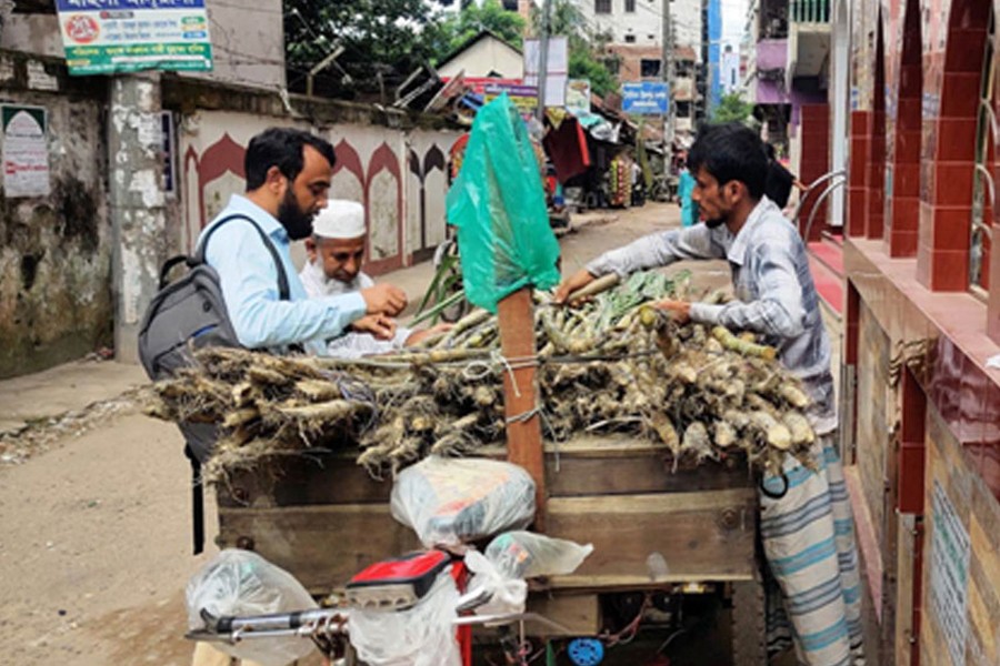 People seen buying sugarcane from a vendor beside Chandpur Govt College in the district town