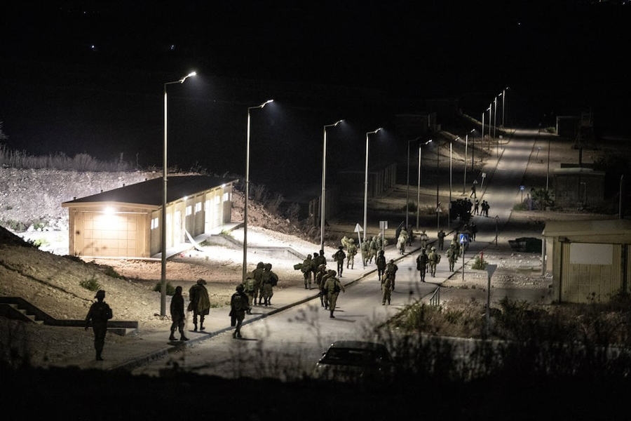Israeli soldiers walk near the scene where a drone from Lebanon attacked Israel, amid cross-border hostilities between Hezbollah and Israel, in Binyamina Israel, October 13, 2024. Lebanon's Hezbollah claimed responsibility for the attack.