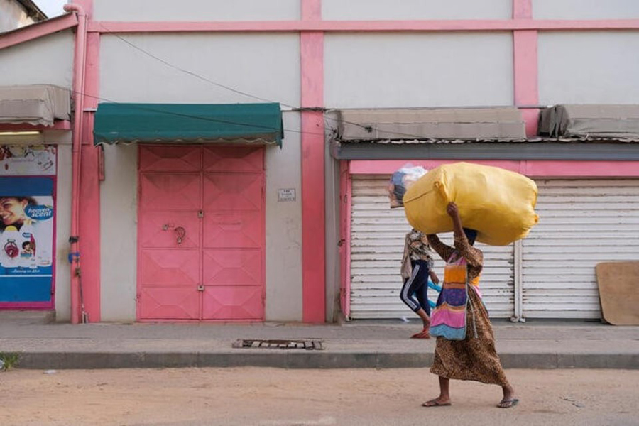 People walk in front of closed shops as traders lock up their stores in protest of Ghana’s worsening economic conditions in Accra, Ghana October 19, 2022.