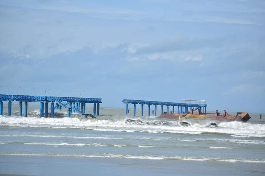 Photo shows the damaged navy jetty at Inani Beach in Cox's Bazar, after being struck by a barge, driven by tidal surges caused by Cyclone Dana