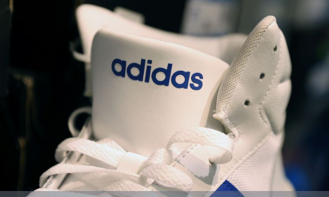 An Adidas shoe is seen in a store at the Woodbury Common Premium Outlets in Central Valley, New York, U.S., February 15, 2022. REUTERS/Andrew Kelly/File Photo