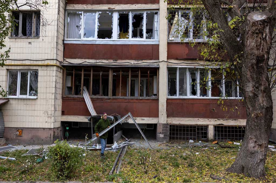 A woman removes debris from an apartment building that was damaged during a Russian drone strike, amid Russia’s attack on Ukraine, in Kyiv, Ukraine Oct 29, 2024