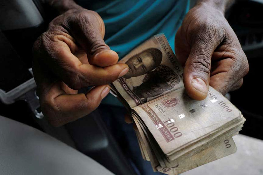 A man counts ₦1000 banknotes in Lagos, Nigeria Aug 6, 2024.