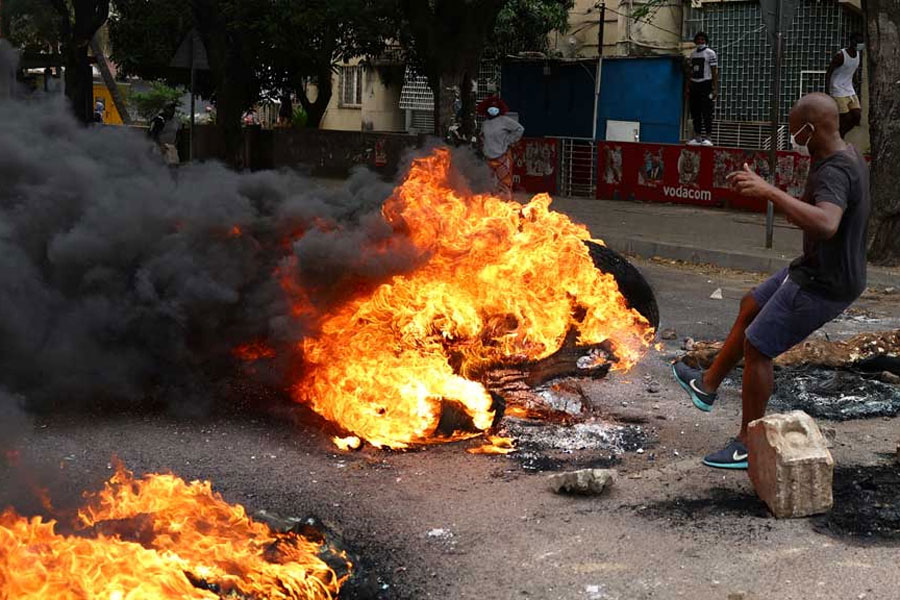 A protester reacts near a burning barricade during a “national shutdown” against the election outcome, at Luis Cabral township in Maputo, Mozambique, November 7, 2024.