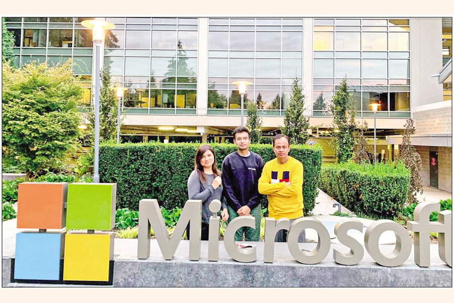 Mohaimen Khan with his parents in front of his workplace