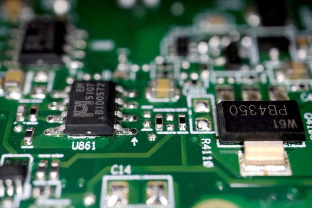 Semiconductors are seen on a printed circuit board in this illustration picture taken February 17, 2023. REUTERS/Florence Lo/File Photo