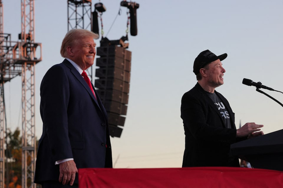 Tesla CEO and X owner Elon Musk speaks as Republican presidential nominee and former US president Donald Trump looks on during a rally at the site of the July assassination attempt against Trump, in Butler, Pennsylvania, US, October 5, 2024.