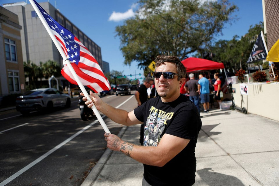A supporter of Republican presidential nominee Donald Trump rallies outside an early polling precinct as voters cast their ballots in local, state, and national elections, in Clearwater, Florida, US, November 3, 2024.