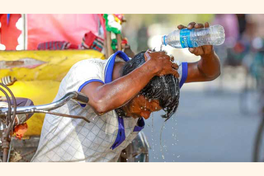 A rickshaw puller pours water on head as temperature rises in Dhaka —Agency Photo