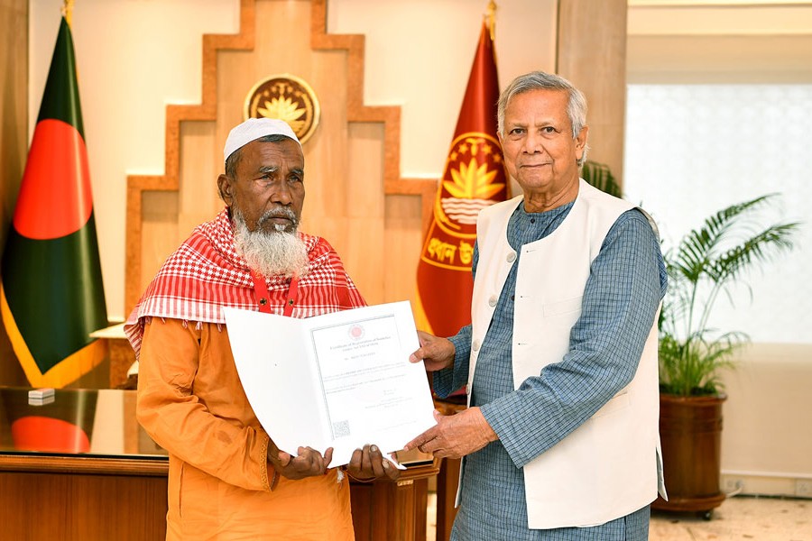 Chief Adviser Professor Muhammad Yunus handing over the certificate of the Shahid Abu Sayed Foundation to Mokbul Hossain, father of Abu Sayed, in a brief ceremony at his office in the capital on Thursda