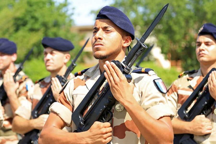 French soldiers stand at attention during a morning drill at the French military base in Chadian capital N'Djamena, October 26, 2014.