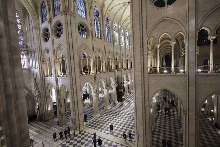 People stroll in Notre-Dame de Paris cathedral while French President Emmanuel Macron visits the restored interiors the monument, Nov.29, 2024 in Paris.