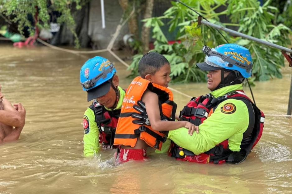 Rescue workers evacuate a child stranded by flooding in Sateng Nok, Yala Province, Thailand, November 30, 2024, in this picture obtained from social media. Poh Teck Tung Foundation/via REUTERS