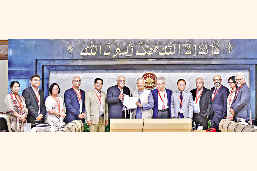 Dr Debapriya Bhattacharya, head of the committee formed to prepare the 'White Paper on the State of Bangladesh Economy', hands over the draft report to Prof Dr Muhammad Yunus, chief adviser of the interim government, at the latter's Tejgaon office in Dhaka on Sunday. — PID