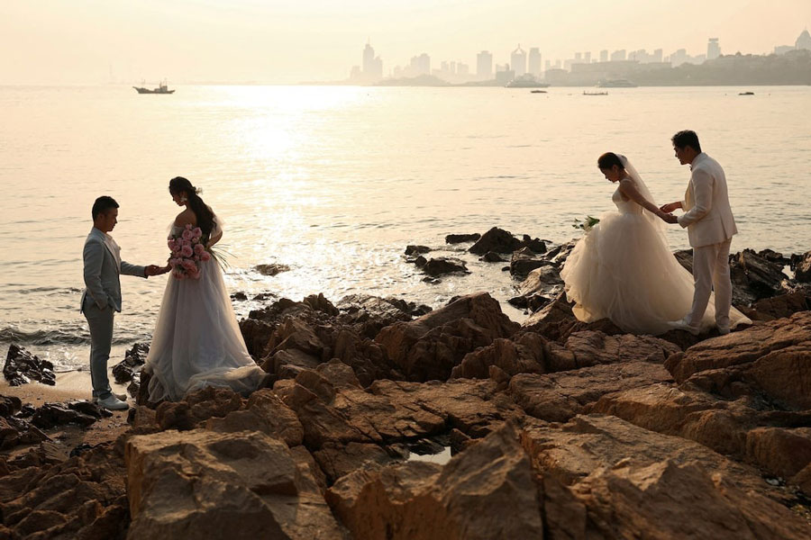 Couples take part in pre-wedding photoshoots by the sea in Qingdao, Shandong province, China April 21, 2024.