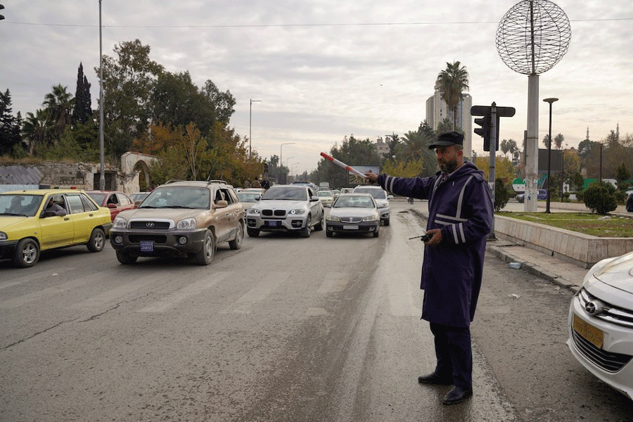 A traffic police directs cars, after rebels took the main northern city of Aleppo and have since pushed south from their enclave in northwest of the country, in Aleppo, Syria, December 4, 2024.