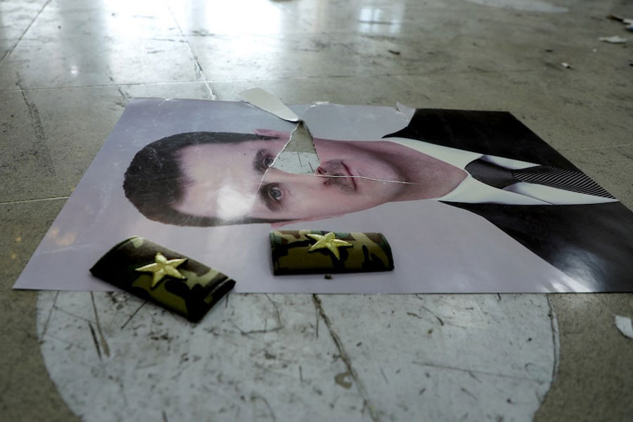 A damaged picture of Syria’s Bashar al-Assad lies on the floor inside Qamishli international airport, after Syrian rebels announced that they had ousted Syria’s Bashar al-Assad, in Qamishli, Syria, December 9.