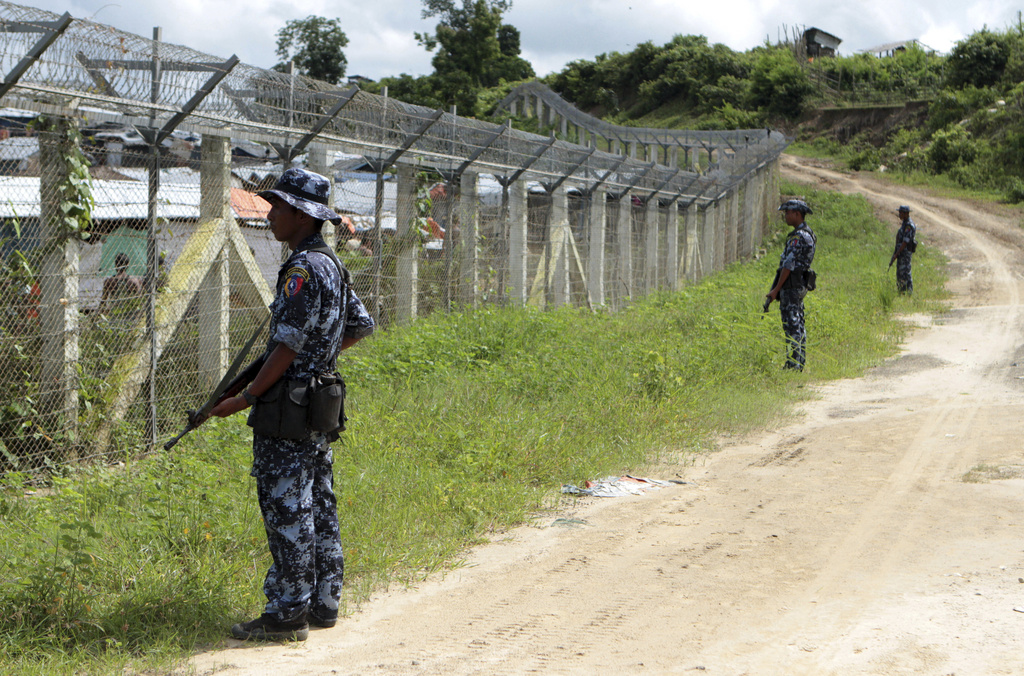 Myanmar border guards stand to provide security near the fence at a no-man's land between Myanmar and Bangladesh, near Taungpyolatyar village, Maungdaw, northern Rakhine State, Myanmar, on June 29, 2018. (AP Photo/Min Kyi Thein, File)