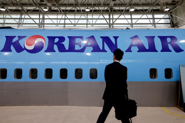 A man walks next to the logo of Korean Air airlines during an organised media tour, at the company's Cabin Crew Training Center in Seoul, South Korea, June 27, 2024. REUTERS/Kim Soo-hyeon/File Photo