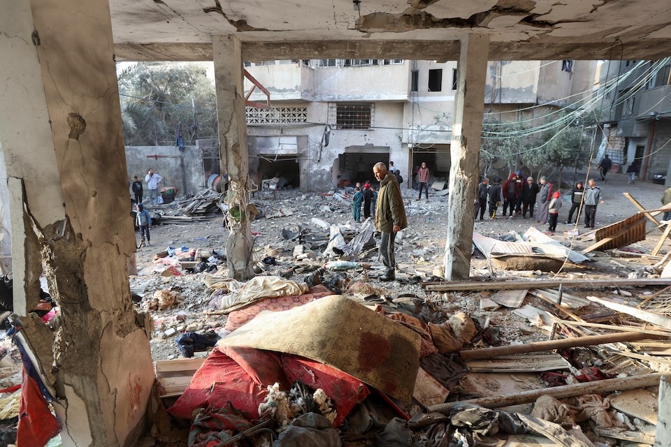 Palestinian inspect damage at the site of an Israeli strike on a house, amid the Israel-Hamas conflict, at the Nuseirat refugee camp in the central Gaza Strip on December 12, 2024 — Reuters photo