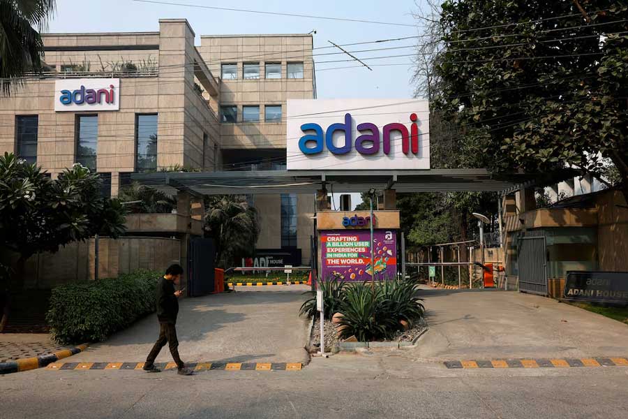 A man walks past a corporate office of Adani Group in Gurugram, India, November 22, 2024.