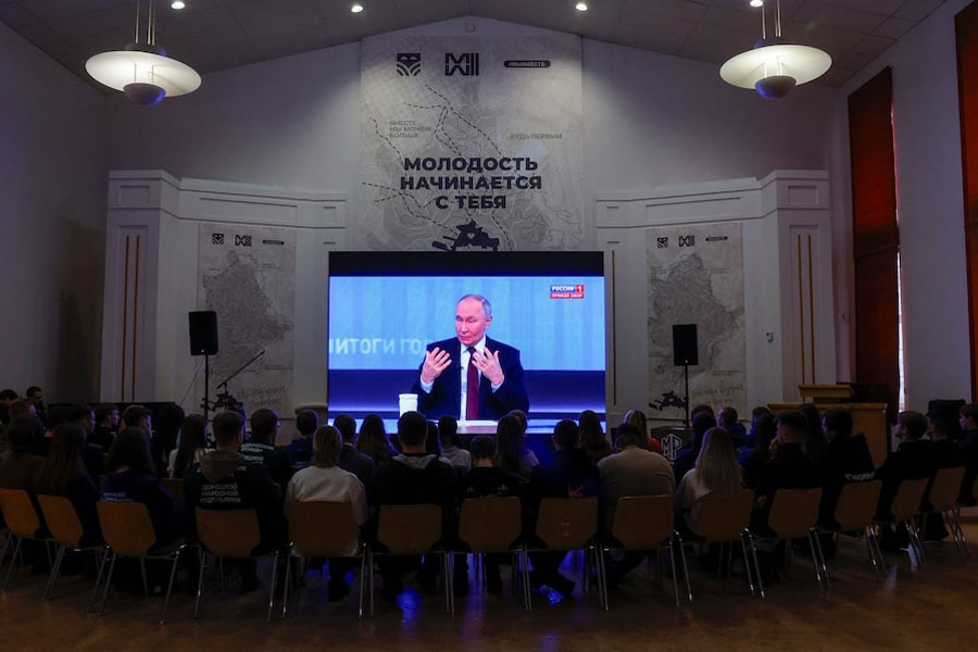 People watch the live broadcast of Russian President Vladimir Putin's annual televised year-end press conference and phone-in, in the course of Russia-Ukraine conflict at a cultural centre in Donetsk, Russian-controlled Ukraine, December 19, 2024.