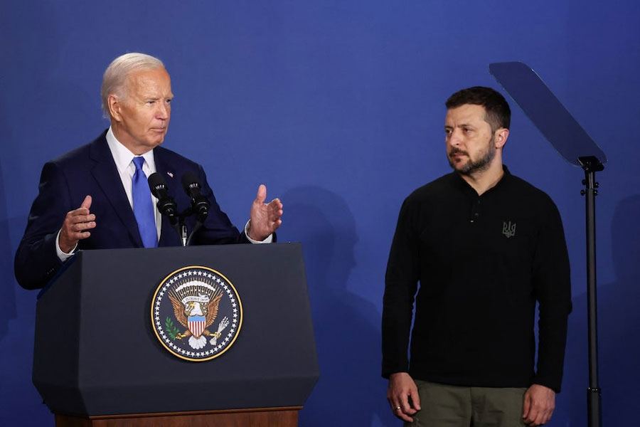 Ukraine’s President Volodymyr Zelenskiy listens to US President Joe Biden speak at a Ukraine Compact meeting, on the sidelines of the NATO’s 75th anniversary summit in Washington, US July 11, 2024.
