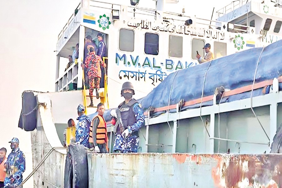 Members of security forces stand guard on MV Al-Bakhera following the recovery of five beheaded bodies from the vessel in the Padma River on Monday