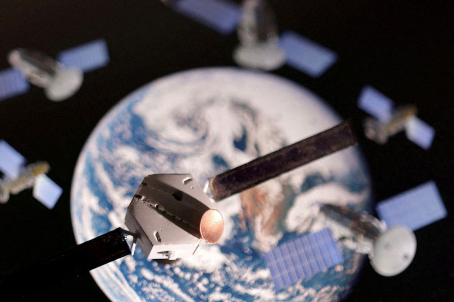 A satellite model is placed on a picture of Earth in this illustration taken November 25, 2024.
