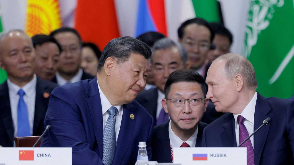 Russian President Vladimir Putin and Chinese President Xi Jinping speak during a plenary session in the outreach/BRICS Plus format at the BRICS summit in Kazan, Russia October 24, 2024. REUTERS