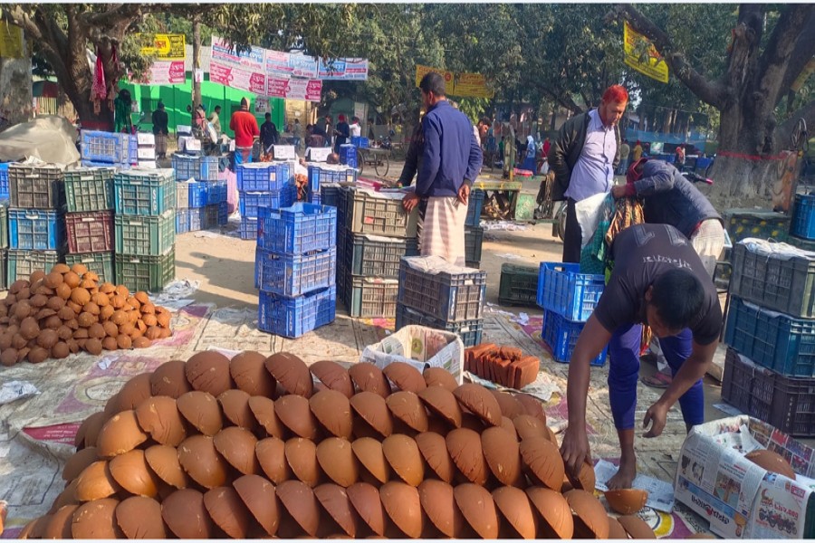 Sellers busy placing date palm molasses in order at Baneshwar market in Rajshahi district