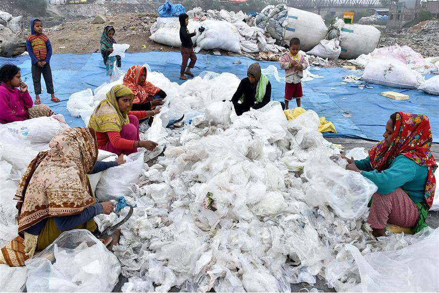 Women process plastic waste at a dumping site in Dhaka, Bangladesh on January 8, 2020 — Xinhua photo