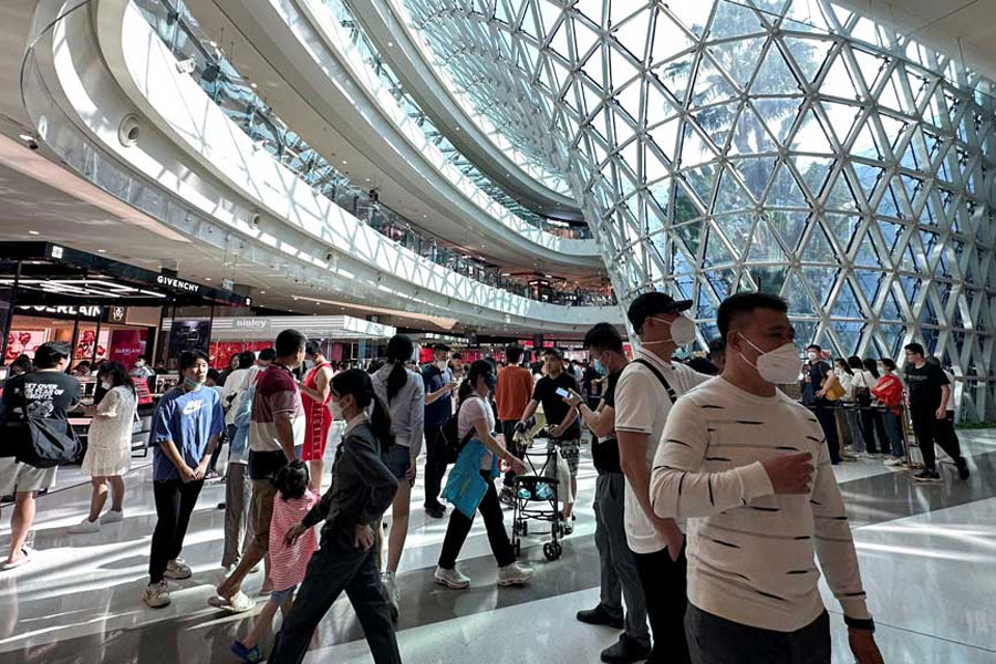 People walk in the Sanya International Duty-Free shopping complex in Sanya, Hainan province, China January 25, 2023.