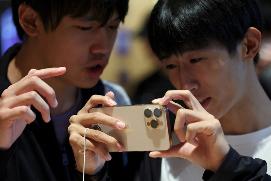 People check an iPhone 16 Pro as the new iPhone 16 series smartphones go on sale at an Apple store in Beijing, China September 20, 2024.