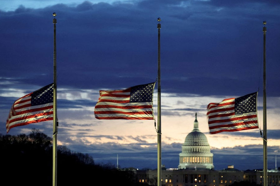 With the US Capitol in the distance, flags fly at half-staff at the Washington Monument on the National Mall following the death of former US President Jimmy Carter, in Washington, US, December 30, 2024.
