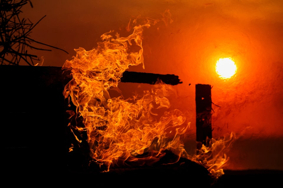 Flames rise from a beachfront home along the road to Malibu, as powerful winds fueling devastating wildfires in the Los Angeles area force people to evacuate, California, US January 8, 2025. REUTERS/Mike Blake