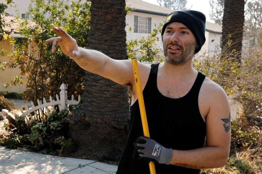 Altadena resident Tristin Perez, who stayed to protect his and his neighbors’ homes during the Eaton Fire, one of six simultaneous blazes that have ripped across Los Angeles County, gestures as he speaks in Altadena, California, US, January 11, 2025.