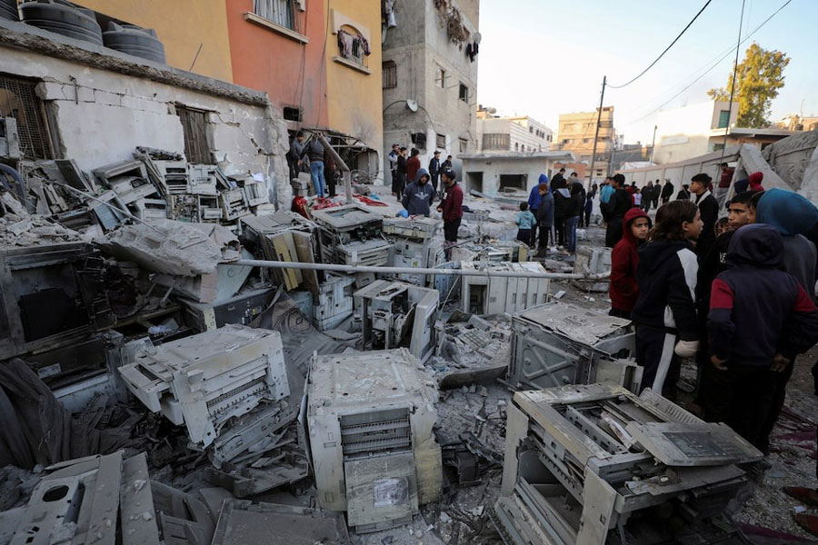 Palestinians gather at the site of an Israeli strike on a school sheltering displaced people, amid the ongoing conflict between Israel and Hamas, in Gaza City January 13, 2025.