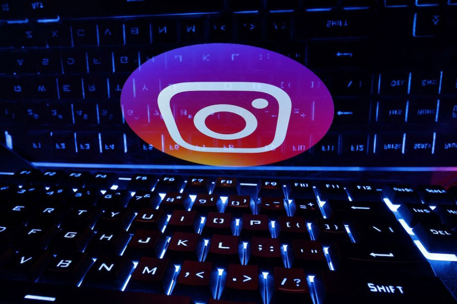 A keyboard is placed in front of a displayed Instagram logo in this illustration taken February 21, 2023.