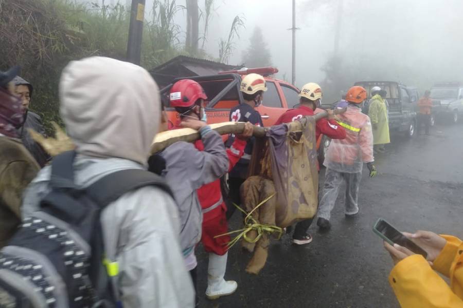 In this photo released by Indonesia’s National Disaster Management Agency (BNPB), rescuers carry the body of a victim of flash flood in Pekalongan, Central Java, Indonesia on Tuesday, Jan. 21, 2025.