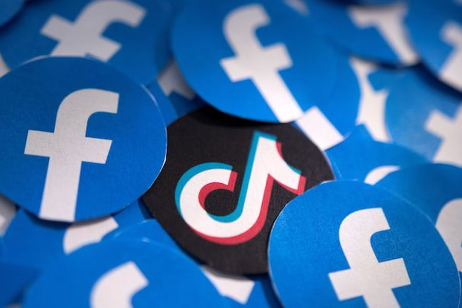 Printed Facebook and TikTok logos are seen in this illustration taken February 15, 2022.