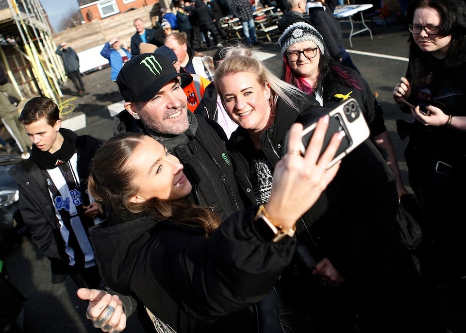 Soccer Football - FA Trophy - Fifth Round - Chorley v Solihull Moors - Victory Park, Chorley, Britain - February 10, 2024 Boyzone member Shane Lynch poses for a selfie with fans before the match.