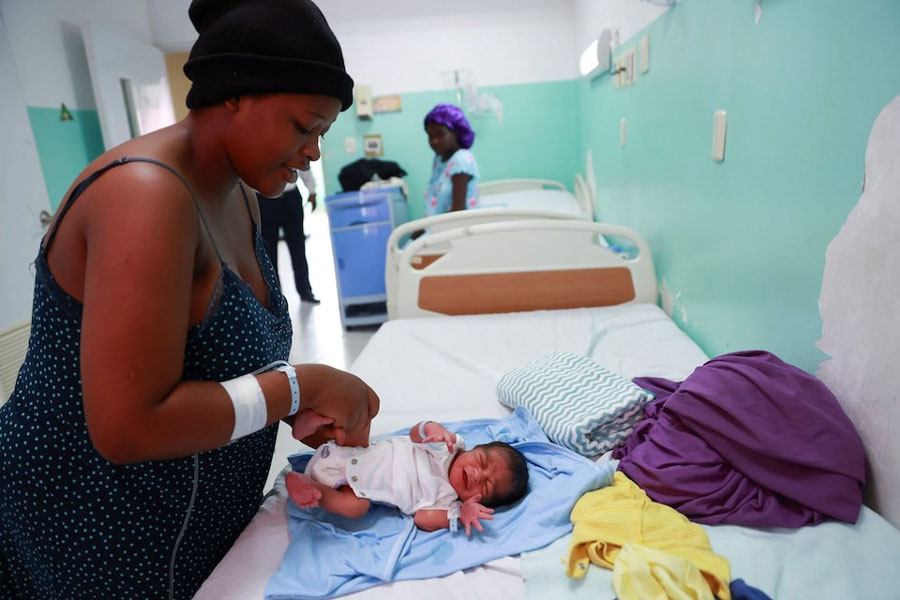 A Haitian mother tends to her baby after giving birth at a local hospital, in Santo Domingo, Dominican Republic January 17, 2025.