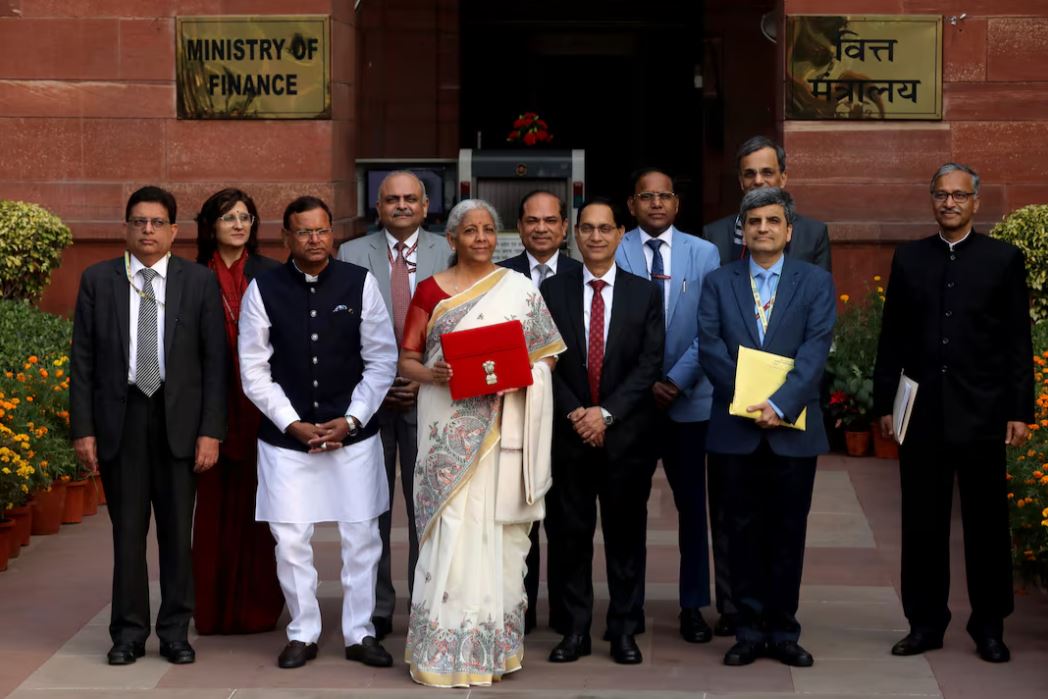 India's Finance Minister Nirmala Sitharaman holds a folder with the Government of India's logo as she poses with her officials while leaving her office to present the annual budget in the parliament, in New Delhi, India, February 1, 2025. REUTERS/Altaf Hussain