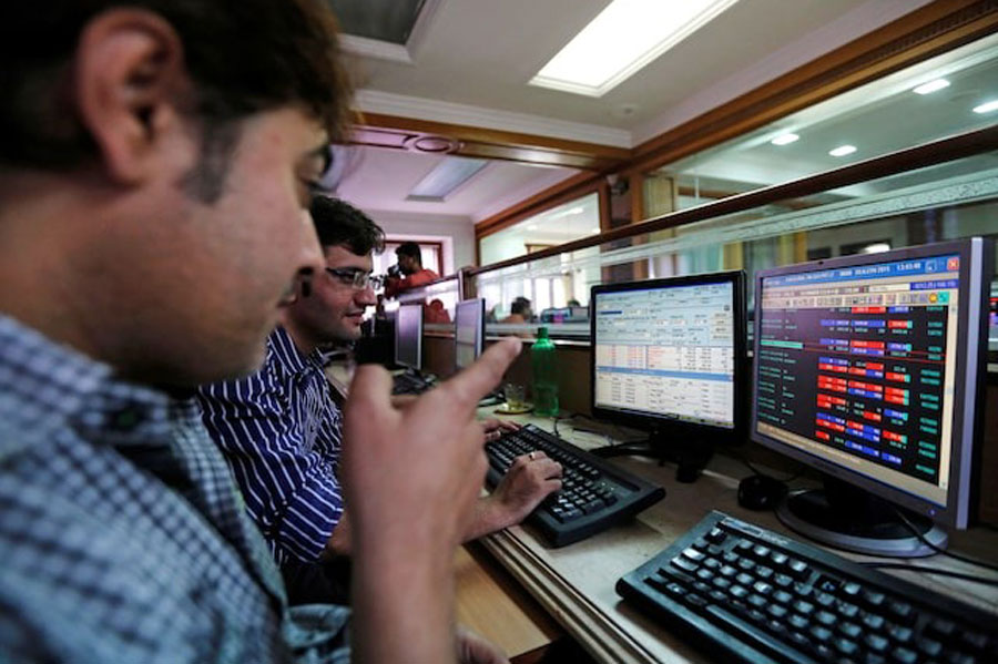Brokers trade at their computer terminals at a stock brokerage firm in Mumbai January 6, 2015.
