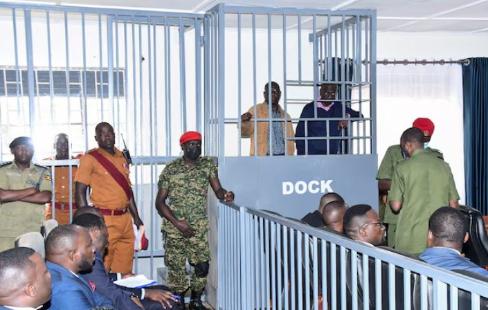 Opposition leader Kizza Besigye and Obeid Lutale stand in a steel dock at the Uganda Military General Court Martial in Makindye, a suburb of Kampala, Uganda December 2, 2024. REUTERS Abubaker Lubowa/File Photo
