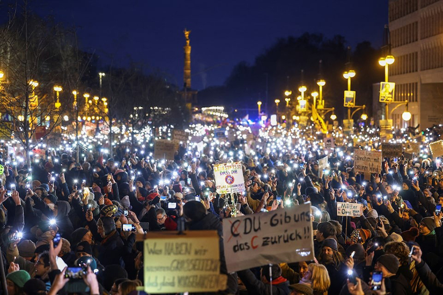 People light up their mobile phones during a protest against the migration plans of the CDU party leader and top candidate for Chancellor Friedrich Merz and the far-right Alternative for Germany party (AfD), in Berlin, Germany on February 2, 2025 — Reuters photo